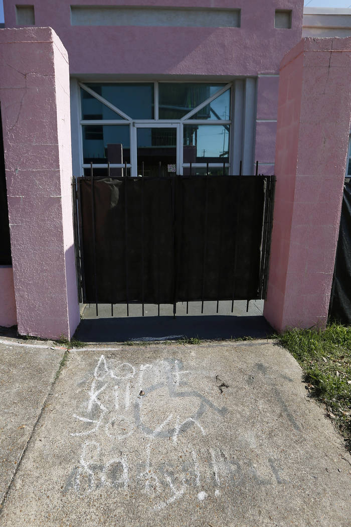 Anti-abortion messages written in chalk are drawn along the sidewalk leading to the Jackson Wom ...