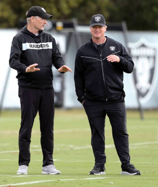 Oakland Raiders general manager Mike Mayock, left, and head coach Jon Gruden watch the team pra ...