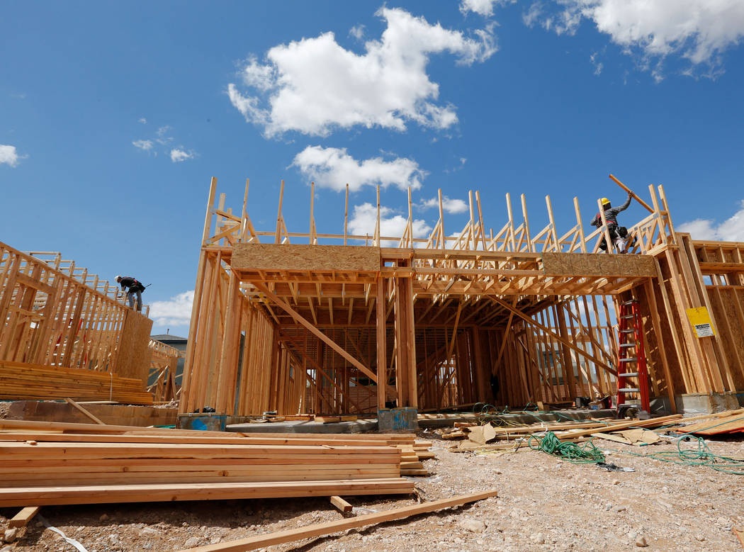 Workers construct houses near the corner of Mesa Park Drive and Hualapai Way in the Summerlin a ...