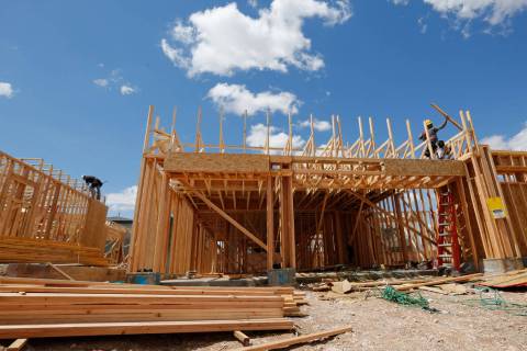 Workers construct houses near the corner of Mesa Park Drive and Hualapai Way in the Summerlin a ...