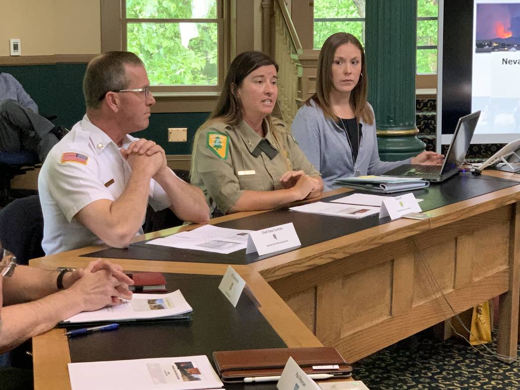 Nevada state forester and fire warden Kasey KC, center, reviews anticipated wildfire risk facin ...