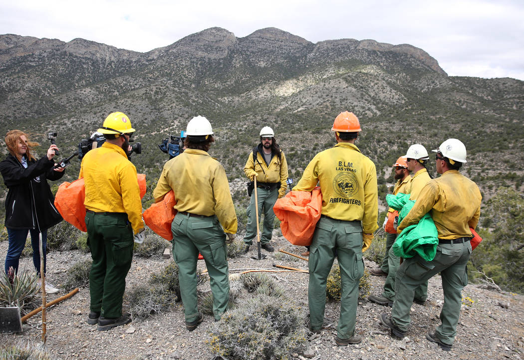 Andrew Merriam, center, squad leader and firefighter at Bureau of Land Management, speaks to hi ...