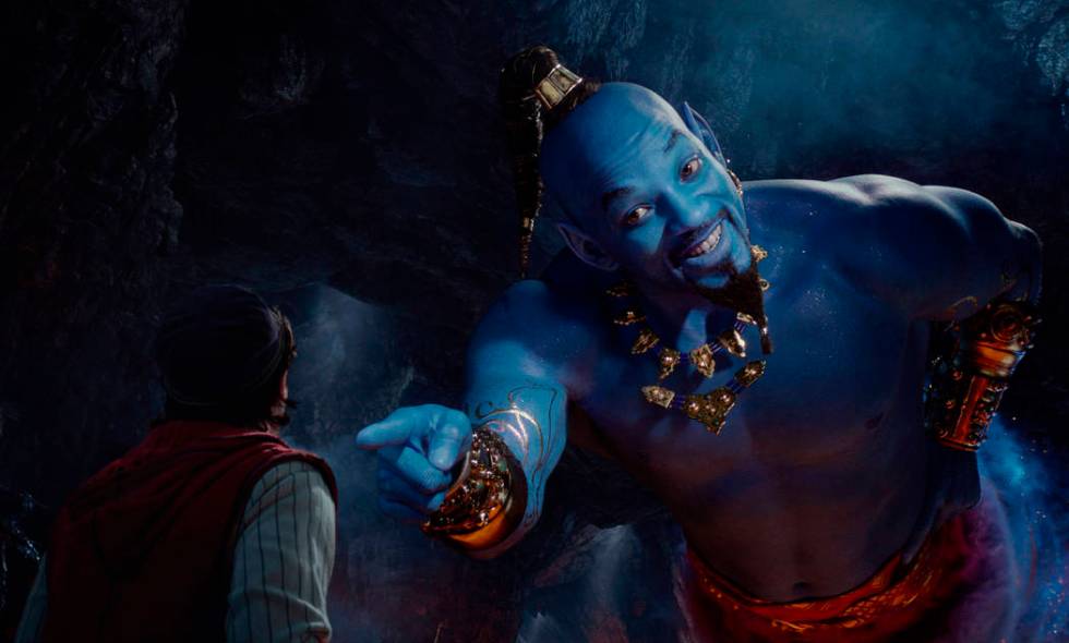 This image released by Disney shows Mena Massoud as Aladdin, left, and Will Smith as Genie in D ...