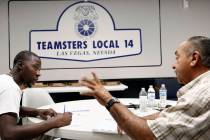 Ernie Ixtlahuac, right, Clark County School District Teamster activist, speaks to Larry Thomas ...