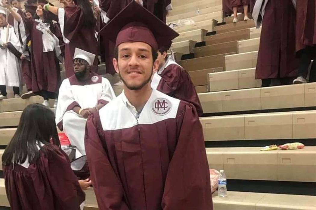 Michael Sigler poses in the cap and gown he was to wear as he graduated from Cimarron-Memorial ...