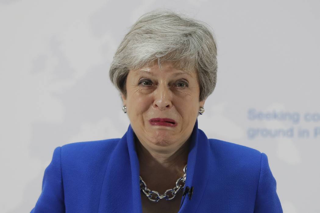 Britain's Prime Minister Theresa May grimaces during her speech in London, Tuesday, May 21, 201 ...