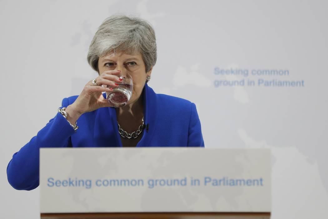 Britain's Prime Minister Theresa May drinks water during a speech in London, Tuesday, May 21, 2 ...