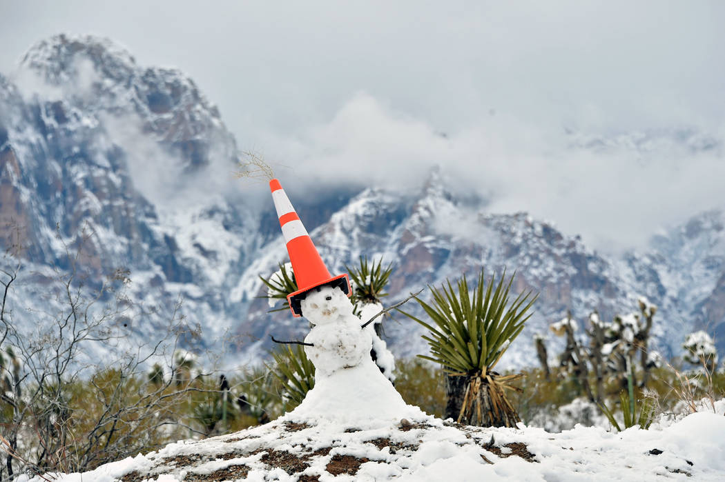 A snowman is capped with a traffic cone at the entrance at Red Rock Canyon National Conservatio ...