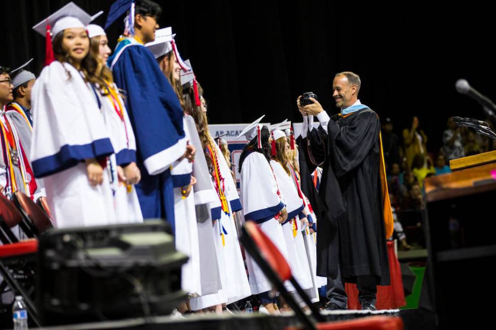 Coronado Principal Mike Piccininni, right, takes photos of students, including valedictorians, ...