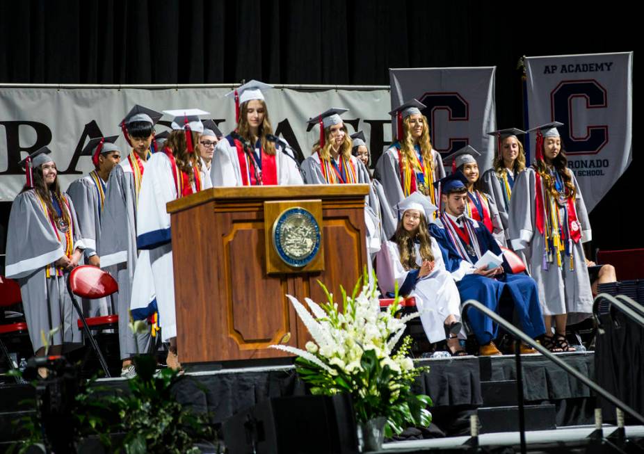 Graduating Coronado High School valedictorians, wearing gray robes, stand to be recognized duri ...