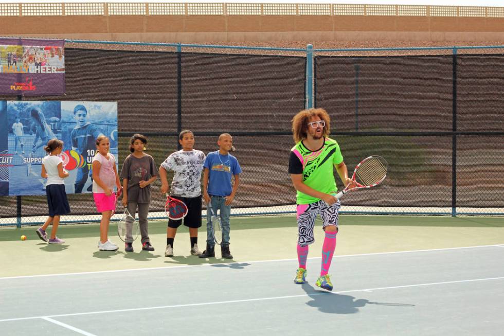 Pop star and tennis buff Redfoo works with youth players at the 2012 Party Rock Open at Darling ...