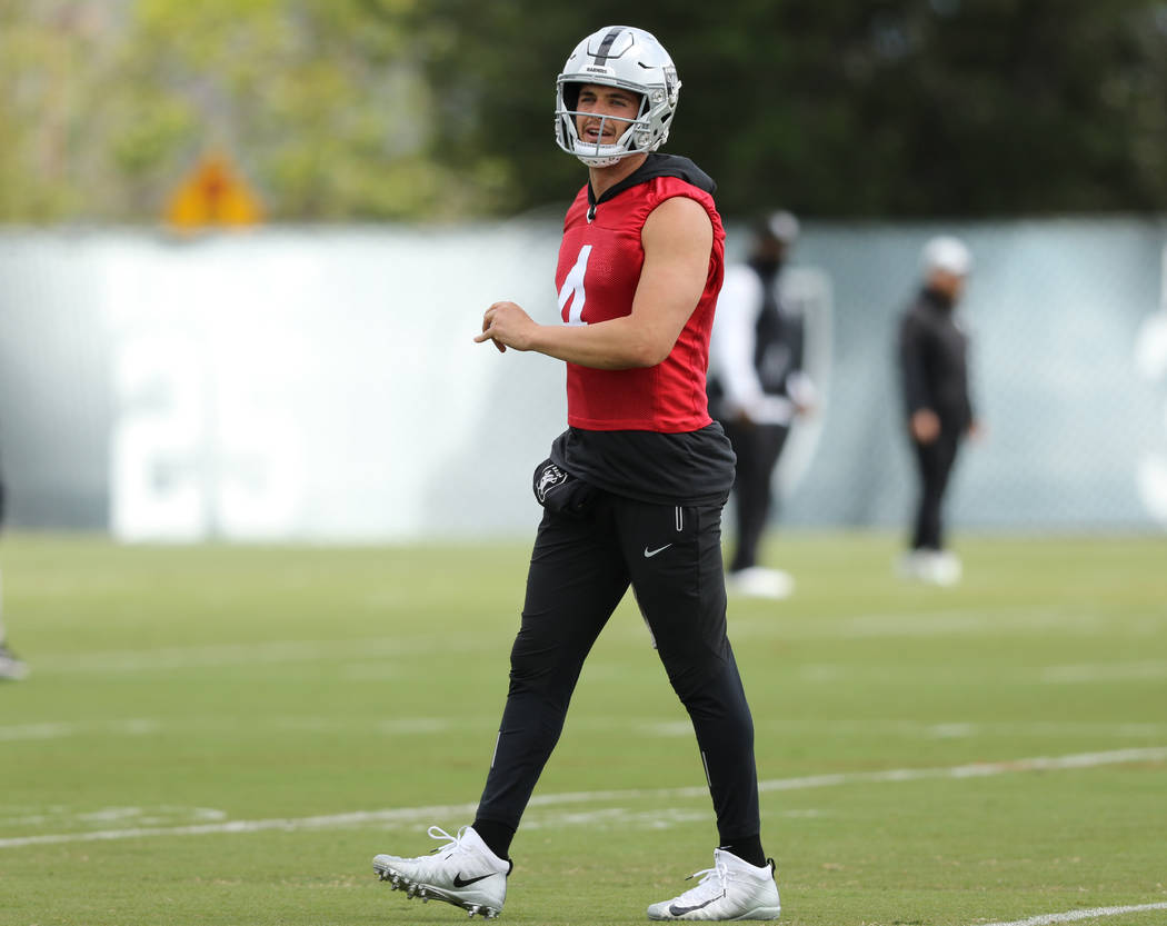 Oakland Raiders quarterback Derek Carr (4) walks on the field at the team's headquarters during ...
