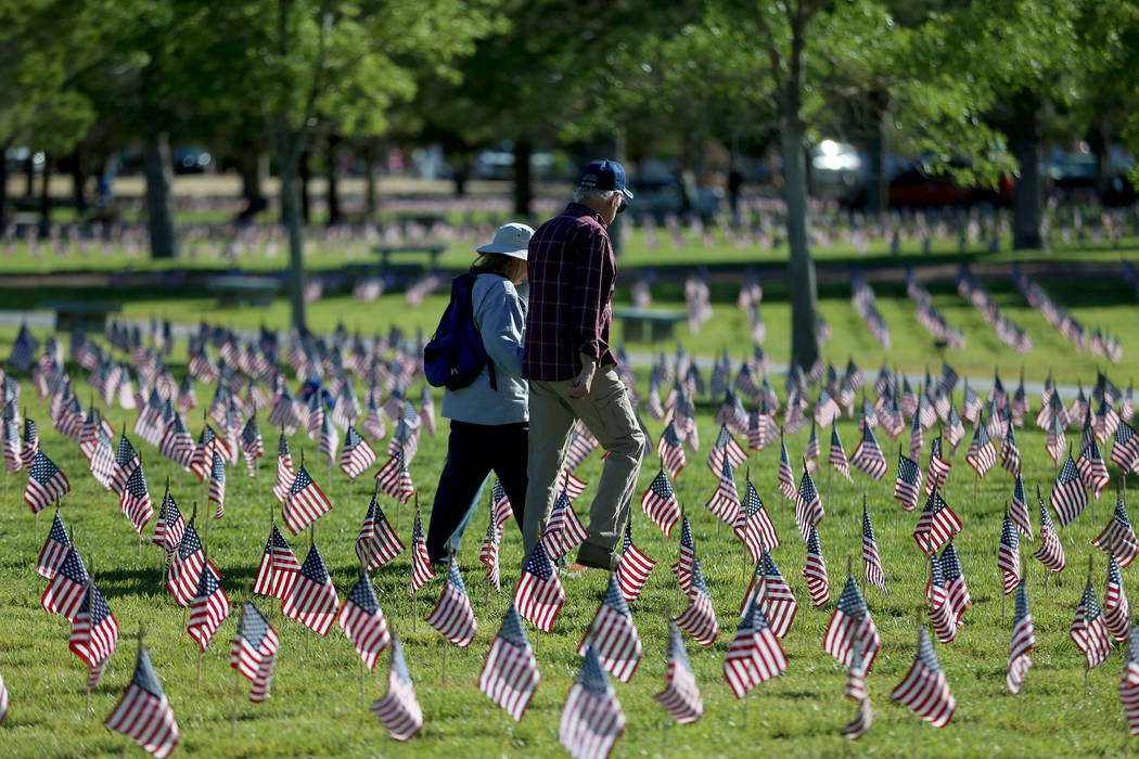 Flags fly above grave sites during the annual “Flag-In” event at the Southern Nev ...