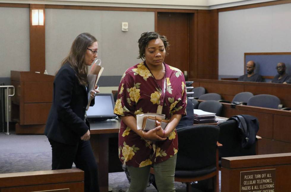 Cadesha Bishop, 25, right, accused of shoving a 74-year-old man off a bus, leaves the courtroom ...