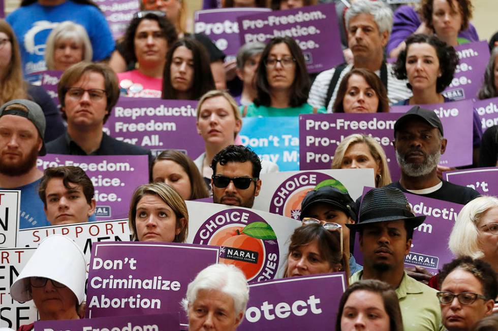 Abortion rights supporters stand during a news conference by Presidential candidate Sen. Kirste ...