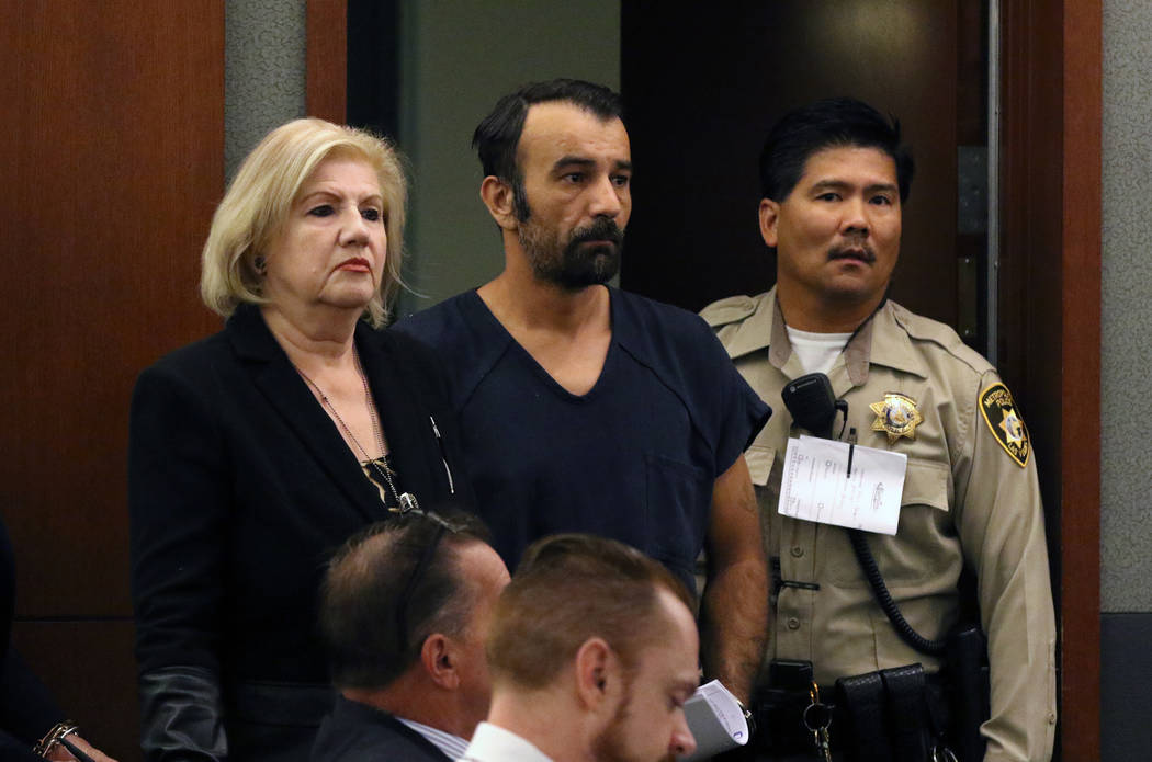 Slobodan Miljus, center, accused of killing his wife with baseball bat, appears in court at the ...