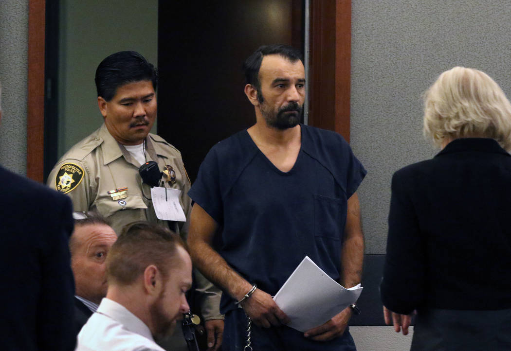 Slobodan Miljus, accused of killing his wife with baseball bat, led into the courtroom at the R ...