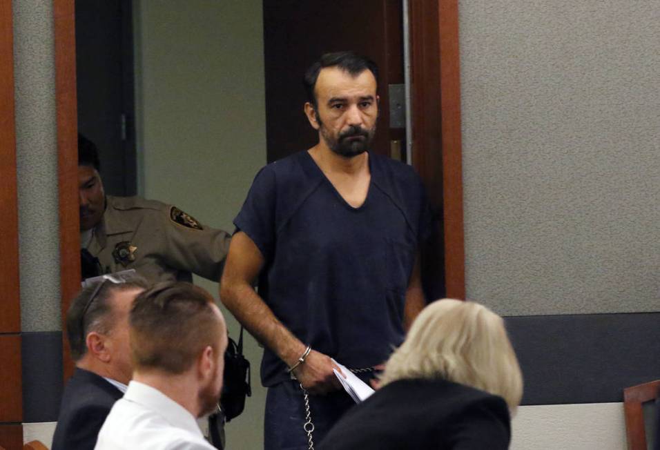 Slobodan Miljus, accused of killing his wife with baseball bat, led into the courtroom at the R ...