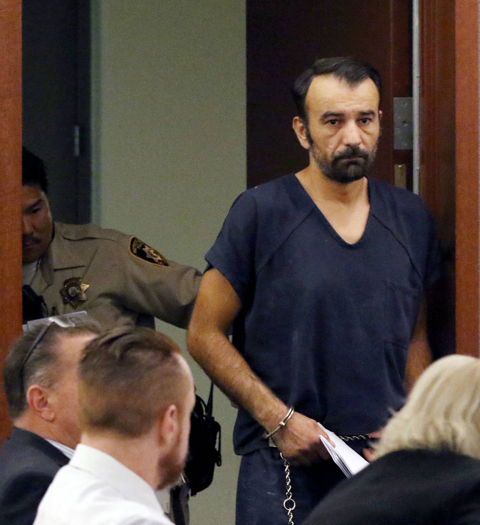 Slobodan Miljus, accused of killing his wife with baseball bat, led into the courtroom at the R ...