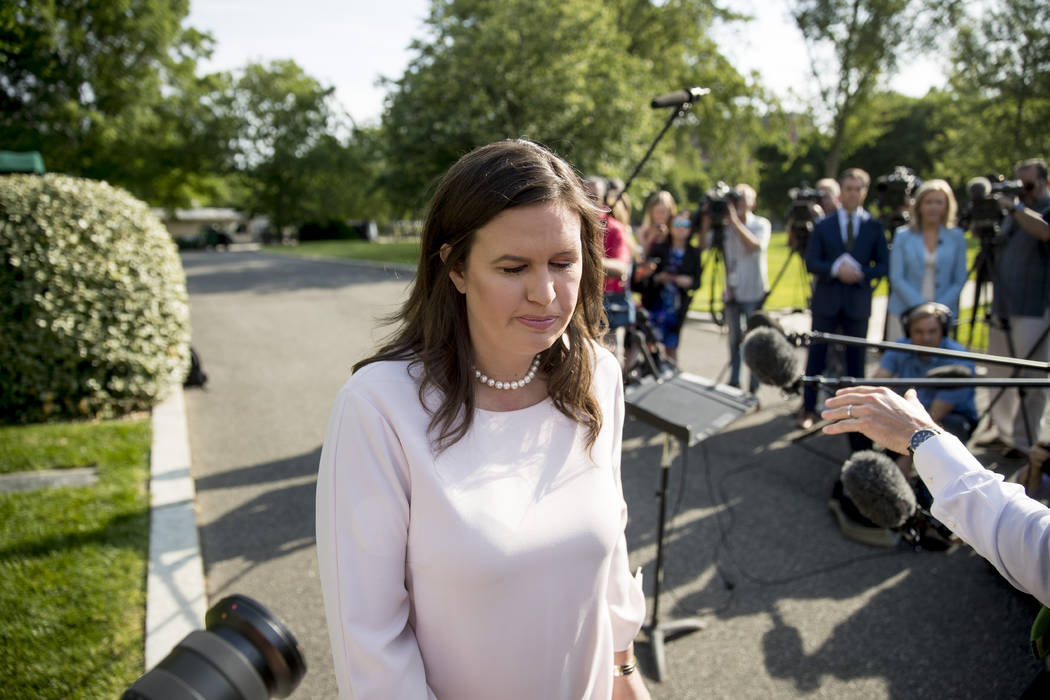 White House press secretary Sarah Huckabee Sanders walks towards the West Wing after speaking t ...