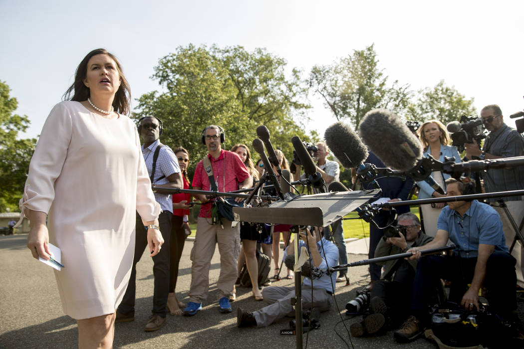 White House press secretary Sarah Huckabee Sanders takes a question from a reporter on the Nort ...