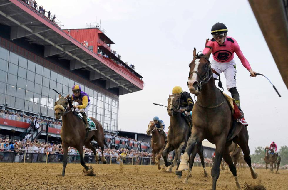 Jockey Tyler Gaffalione, right, reacts aboard War of Will, as they crosses the finish line firs ...