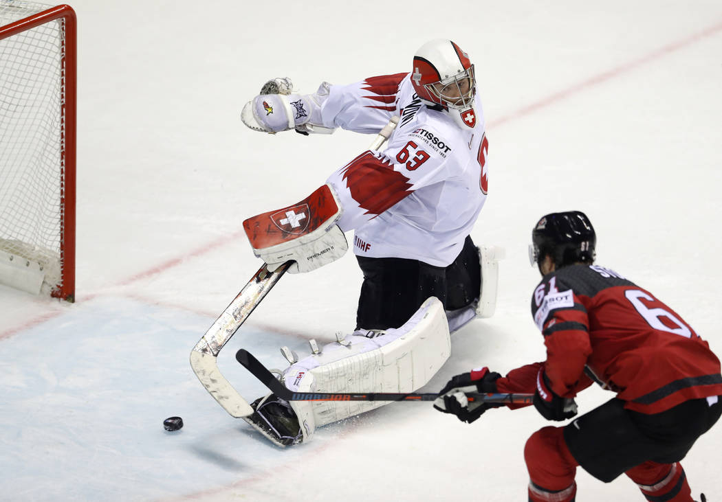 Canada's Mark Stone, right, scores his side's third goal past Switzerland's goalkeeper Leonardo ...