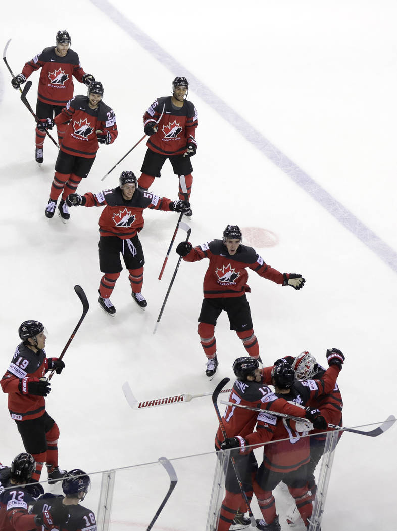 Canada's Mark Stone, 2nd right foreground, celebrates after scoring his side's third goal durin ...