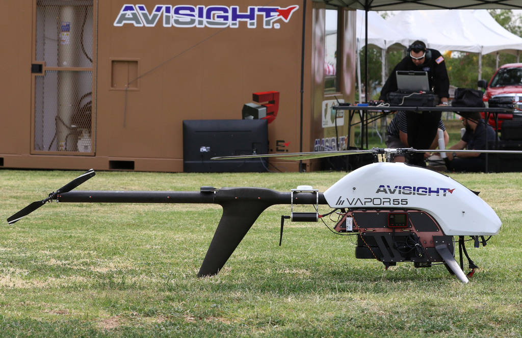 Jason Daub, a pilot in command, prepares to fly the Vapor 55 unmanned helicopter over Craig Ran ...