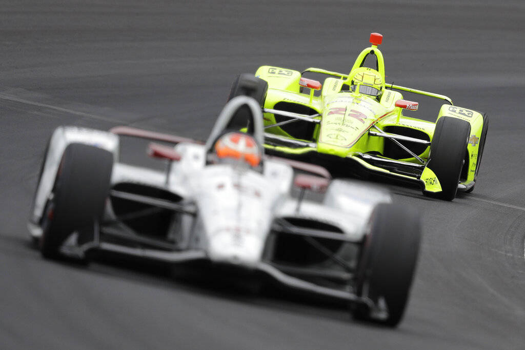 Simon Pagenaud, of France, follows Santino Ferrucci into turn one during practice for the India ...