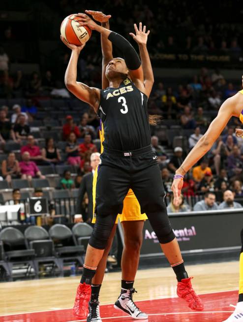 Las Vegas Aces center Kelsey Bone (3) shoots as Los Angeles Sparks center Jantel Lavender (42), ...