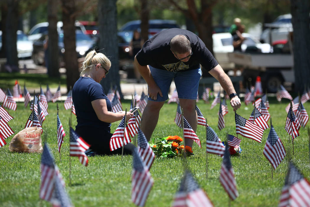 Gus Chaltas visits his parents' grave with his wife Jennifer on Memorial Day at the Southern Ne ...