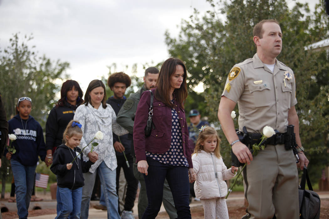 Nicole Beck, the widow of Metro Officer Alyn Beck who died in the line of duty in 2014, walks w ...