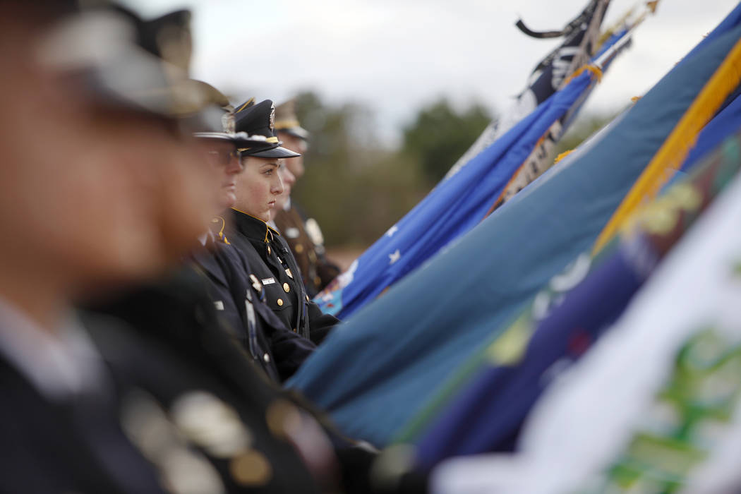 The flag detail stands over the crowd at the Southern Nevada Law Enforcement Officers memorial ...