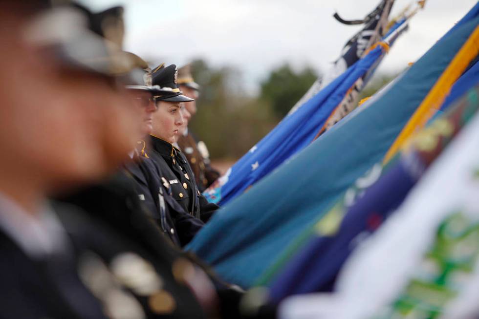 The flag detail stands over the crowd at the Southern Nevada Law Enforcement Officers memorial ...