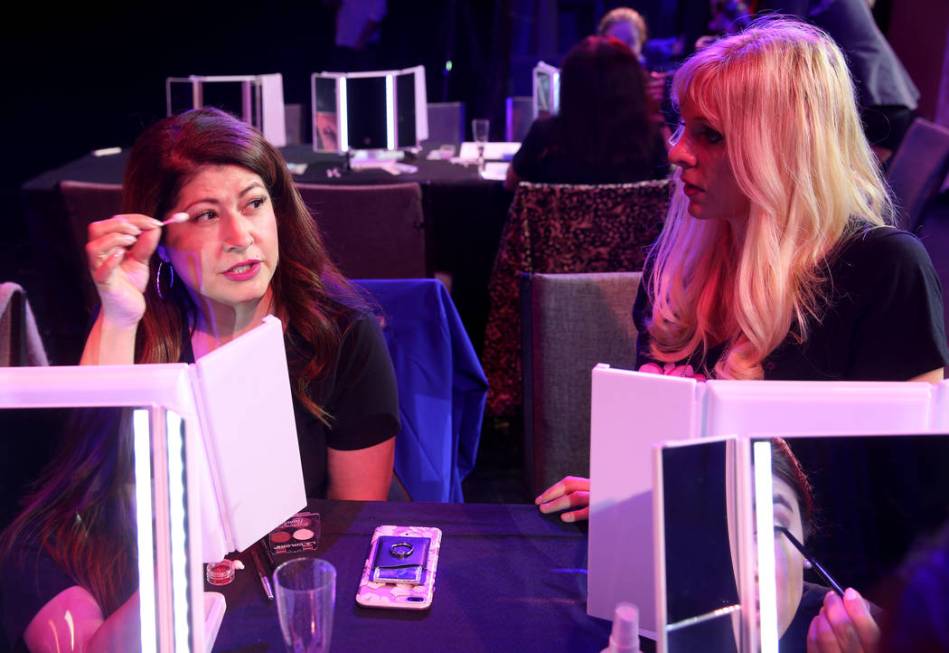 Coache Dar Brzezinski, right, works on makeup with Glenda Damien of Las Vegas during a preview ...