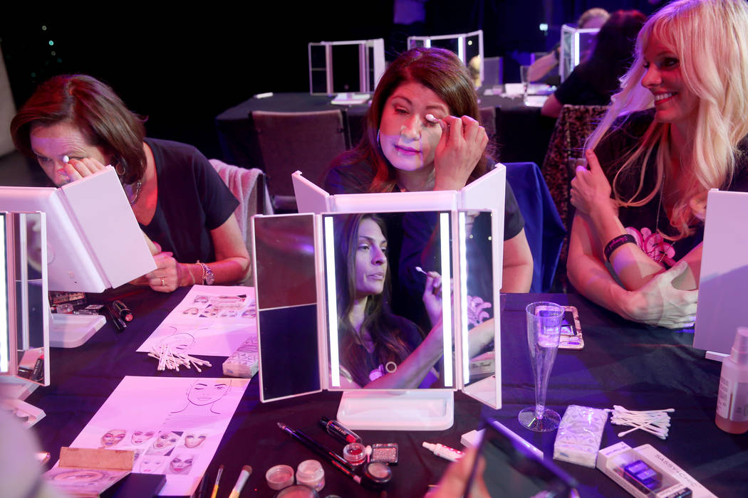 Coach Dar Brzezinski, right, works on makeup with Glenda Damien, center, and Marla Laughlin, bo ...