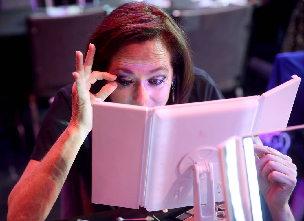 Marla Laughlin of Las Vegas attaches eyelashes during a preview of Showgirl Bootcamp at Saxe Th ...