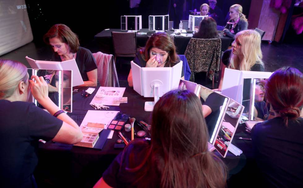 Coach Dar Brzezinski, right, works on makeup with Glenda Damien, center, and Marla Laughlin, bo ...