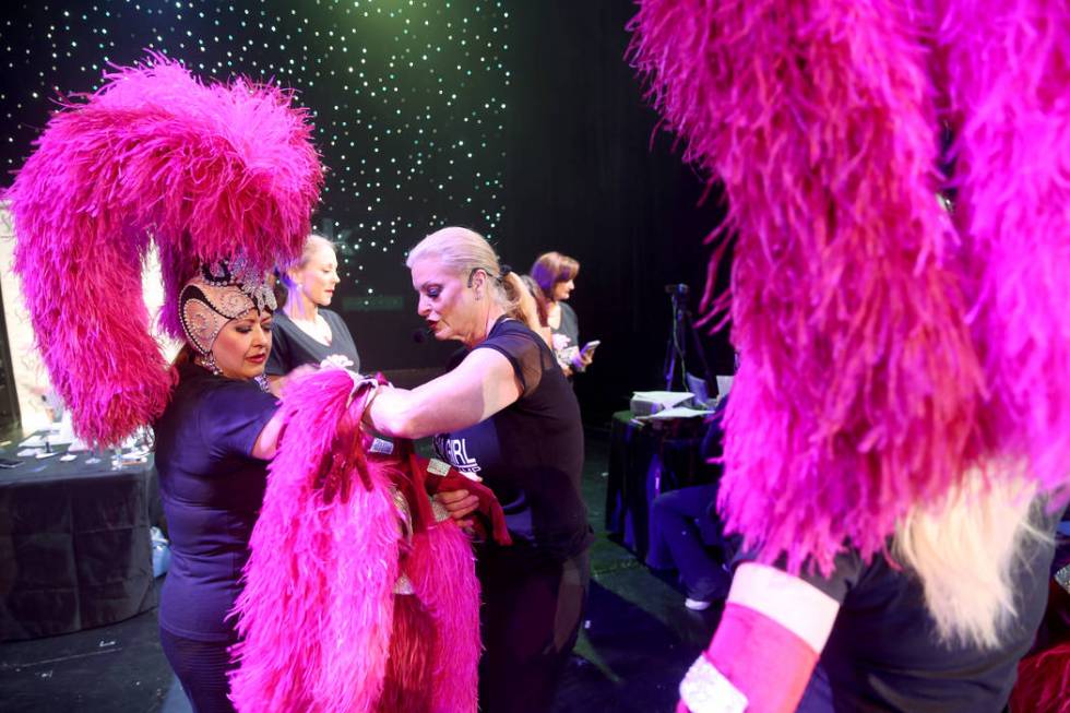 Co-creator Stacy Law-Blind, right, helps Glenda Damien of Las Vegas with gloves during a previe ...