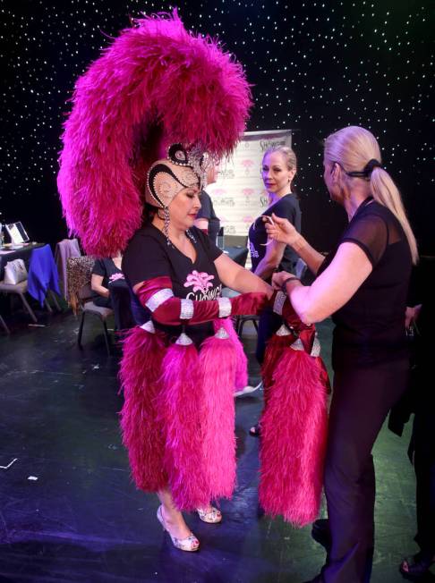 Co-creator Stacy Law-Blind, right, helps Glenda Damien of Las Vegas with gloves during a previe ...