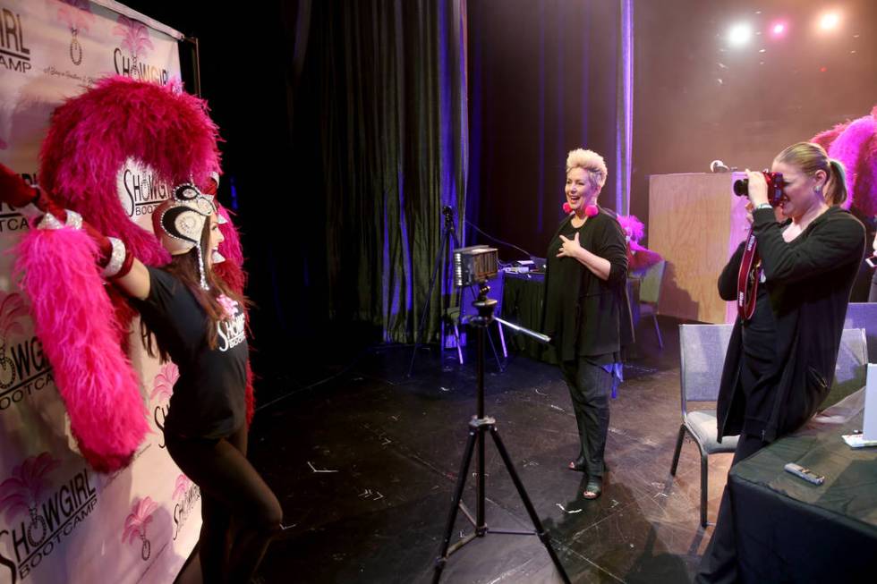 Co-creator Mistinguett, center, helps pose Christi Ahnee of Las Vegas as coach Alison Scheel ta ...