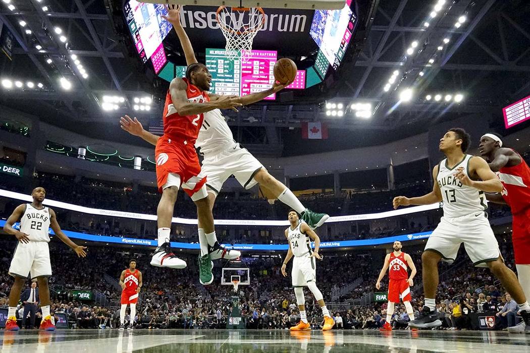 Toronto Raptors' Kawhi Leonard shoots past Milwaukee Bucks' Brook Lopez during the second half ...