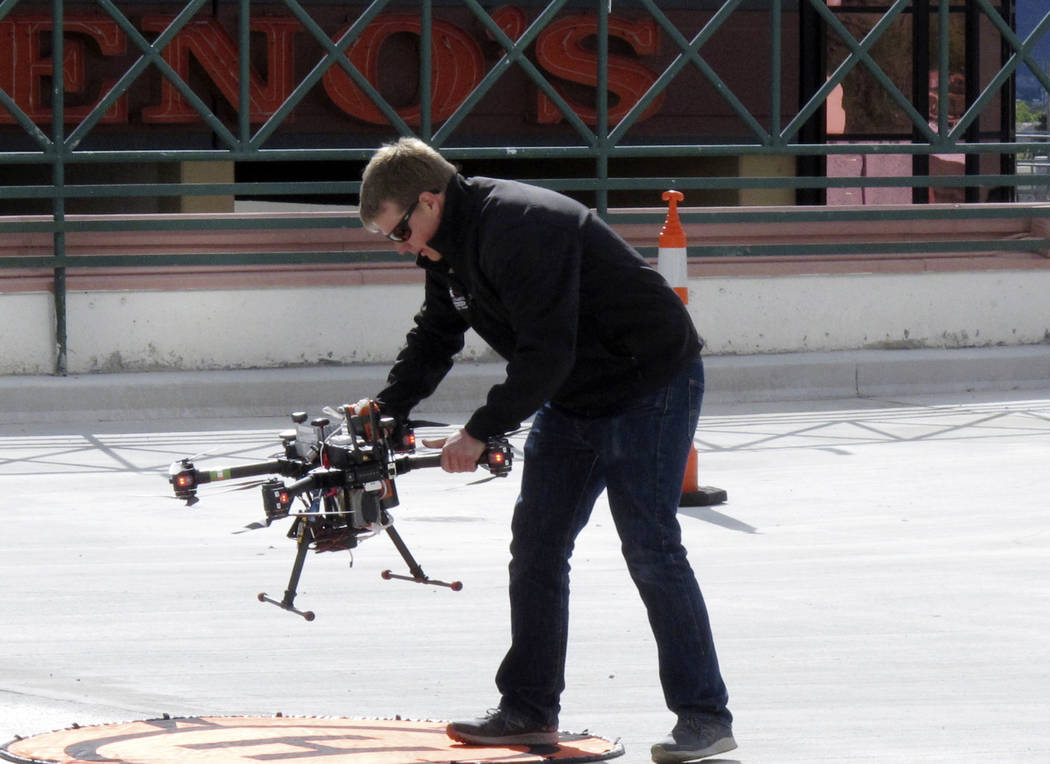 In this Tuesday, May 21, 2019 photo, a researcher positions a drone for take off on the roof o ...
