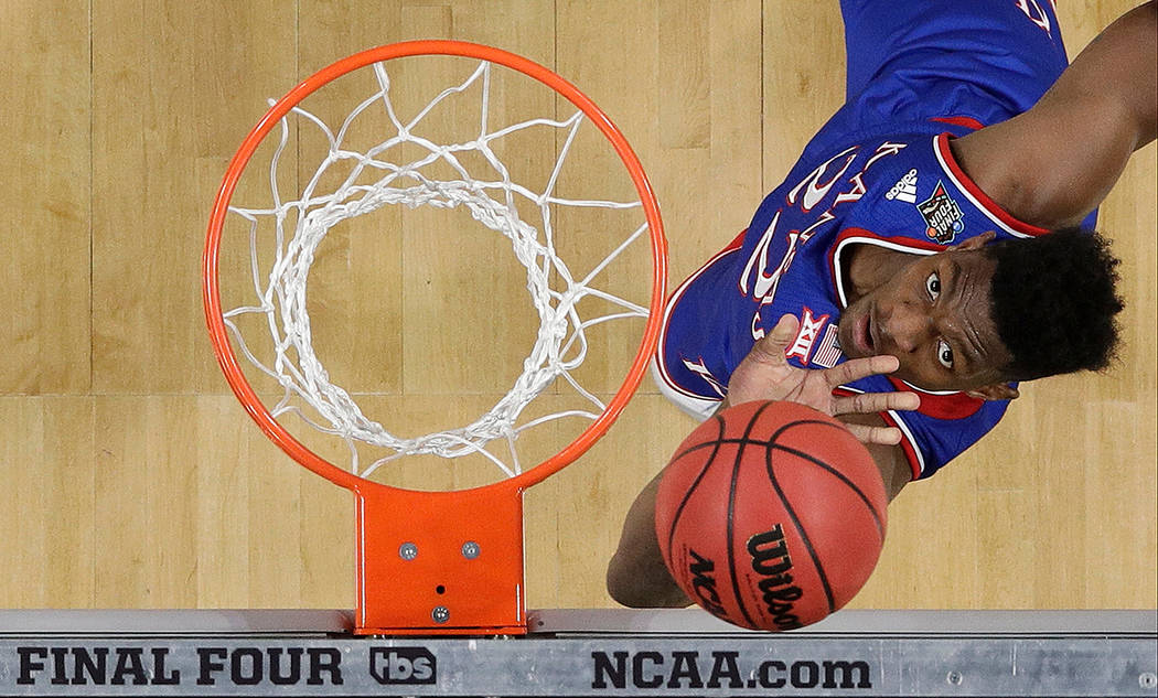 Kansas's Silvio De Sousa (22) watches his shot during the first half in the semifinals of the F ...