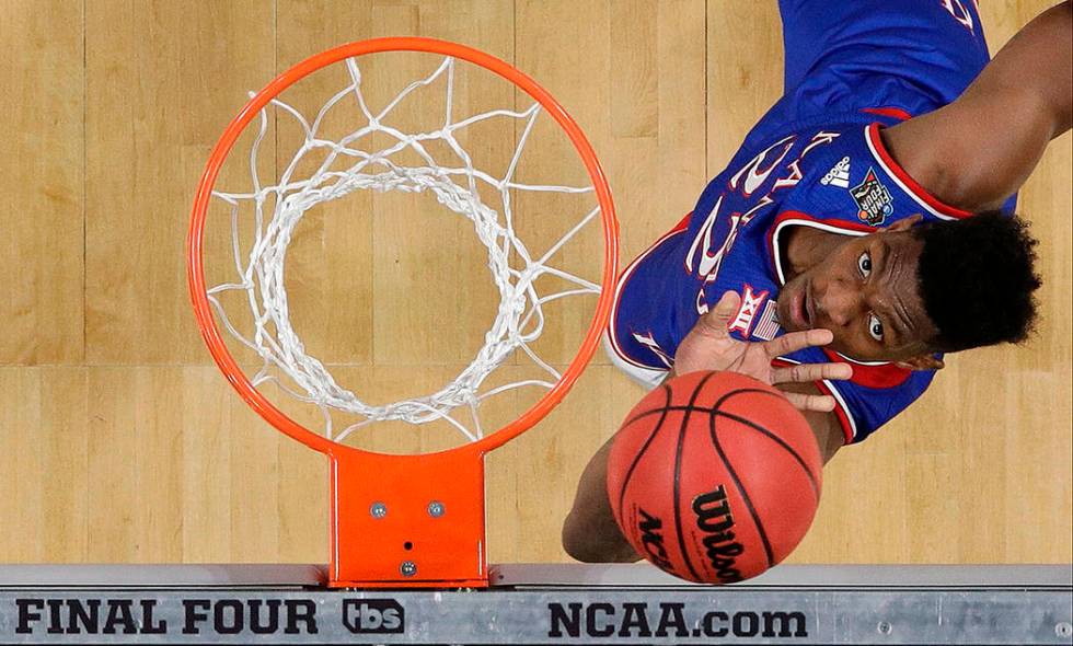 Kansas's Silvio De Sousa (22) watches his shot during the first half in the semifinals of the F ...