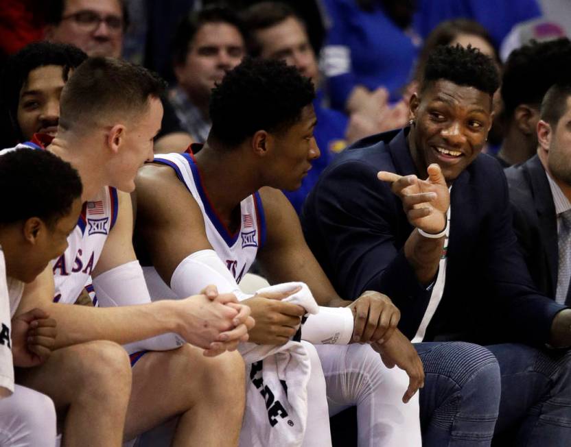 Kansas forward Silvio De Sousa, right, points to teammates during the second half of an NCAA co ...