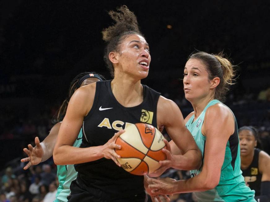 Aces forward Dearica Hamby (5) drives past New York Liberty guard Rebecca Allen (9) in the seco ...