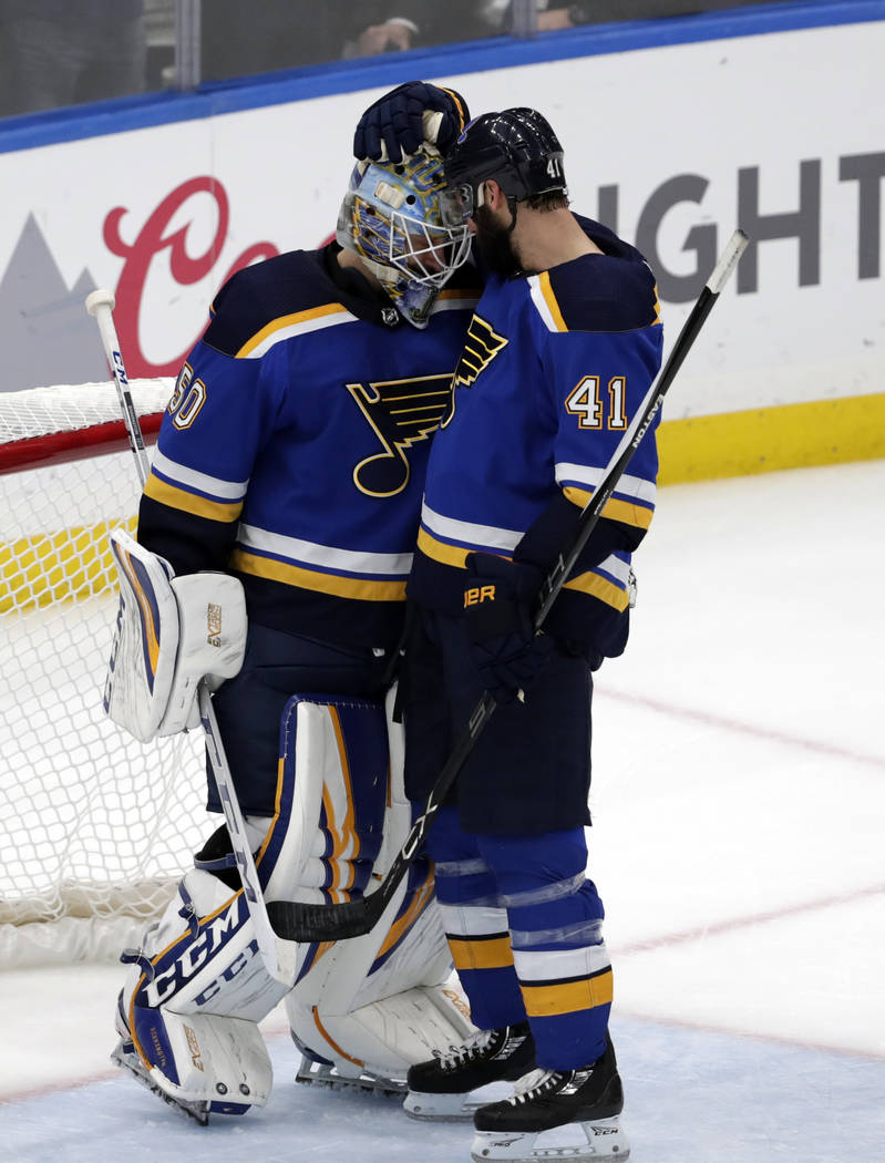 St. Louis Blues goaltender Jordan Binnington (50) and Robert Bortuzzo (41) celebrate after defe ...