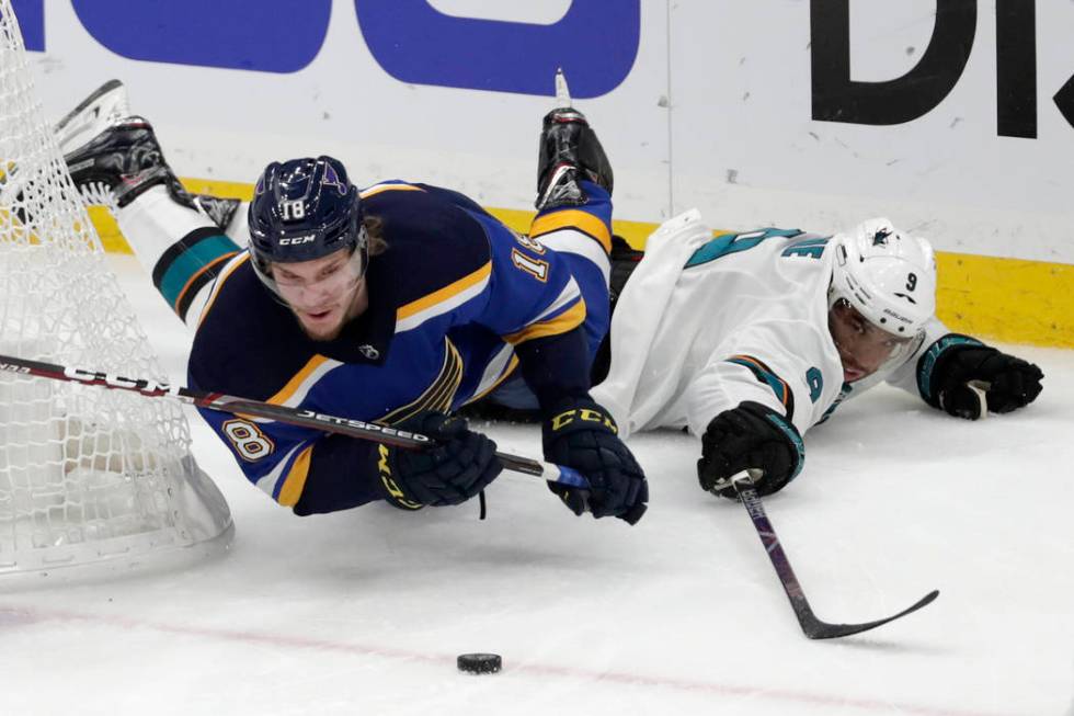 St. Louis Blues center Robert Thomas (18) falls as he chases the puck with San Jose Sharks left ...